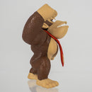 The Donkey Kong figurine displayed on a wooden desk next to a gaming setup to show its true size context.