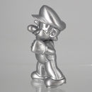 Close up shot of the face and silver cap detail on the official Metal Mario miniature toy.