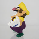 Wario character figure shown alongside the official Nintendo licensed retail packaging.