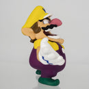 Close up shot of the face, mustache, and yellow cap detail on the official Wario miniature toy.